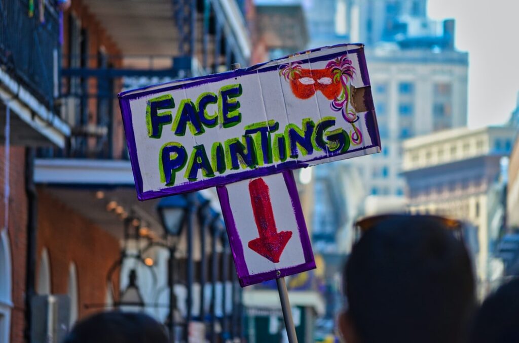Street sign advertising face painting.